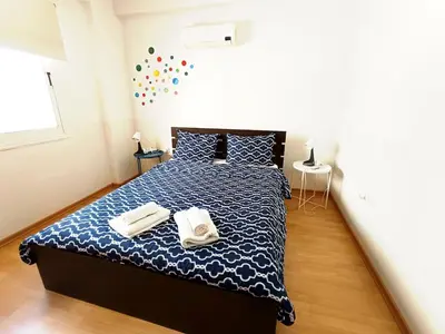 a bedroom with a bed with two towels on it at City Center Walking to the Beach 2 Bedrooms in Larnaka