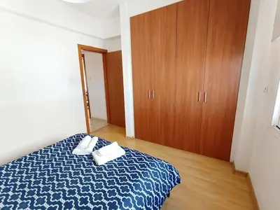 a bedroom with a bed with two towels on it at City Center Walking to the Beach 2 Bedrooms in Larnaka