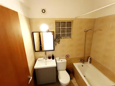 a bathroom with a toilet and a sink and a tub at City Center Walking to the Beach 2 Bedrooms in Larnaka