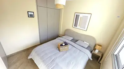 a small bedroom with a bed with a basket on it at Warm Design 3BR, Beach 7-min walk, Peaceful in Larnaka