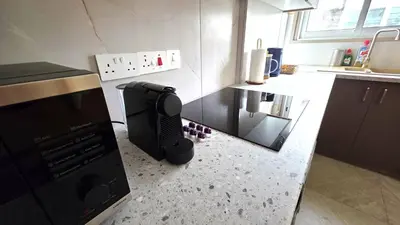 a kitchen with a microwave and a counter top at Warm Design 3BR, Beach 7-min walk, Peaceful in Larnaka