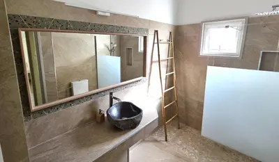 a bathroom with a black sink and a mirror at Warm Design 3BR, Beach 7-min walk, Peaceful in Larnaka