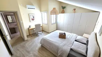 a bedroom with a bed and a desk in it at 3BR Shared Apt - Beach 7-min walk, Peaceful in Larnaka