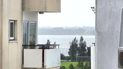 a balcony with a view of the water from a building at 3BR Shared Apt - Beach 7-min walk, Peaceful in Larnaka