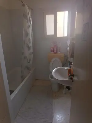 a bathroom with a toilet and a tub and a sink at 1 room at sharing flat in Larnaka