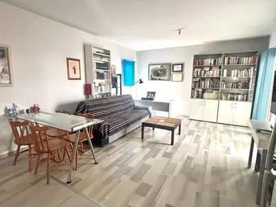 a living room with a couch and a table at Spacious 1 bedroom apartment with an attic bedroom in Strovolos