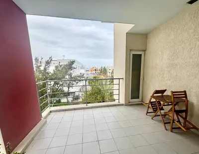 a balcony with a table and chairs and a view at Spacious 1 bedroom apartment with an attic bedroom in Strovolos