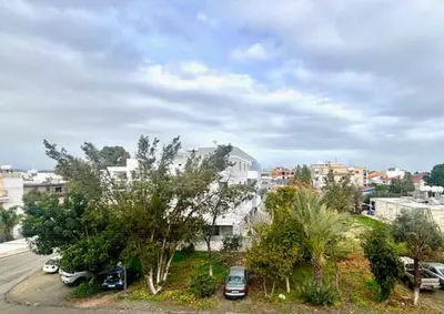 a city with cars parked in a parking lot at Spacious 1 bedroom apartment with an attic bedroom in Strovolos