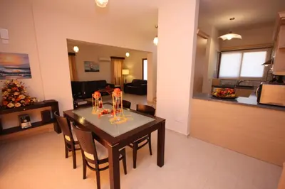 a dining room and living room with a table and chairs at Luxury Villa Rental, Two Bedroom Villa with private pool and garden, in Pissouri