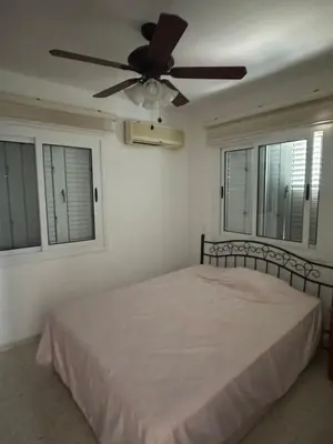 a bedroom with a bed with a ceiling fan at 3 bedroom Villa in Kyrenia, 2 minutes away from the beach! in Strovolos
