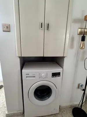 a washer and dryer in a kitchen with a cabinet at 3 bedroom Villa in Kyrenia, 2 minutes away from the beach! in Strovolos
