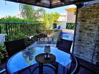 a glass table and chairs on a balcony with a swimming pool at Seana Kapparis Apartment with Private Pool in Aglantzia