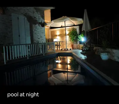 a swimming pool at night with an umbrella at Seana Kapparis Apartment with Private Pool in Aglantzia
