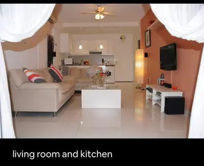 a living room with a couch and a living room and kitchen at Seana Kapparis Apartment with Private Pool in Aglantzia