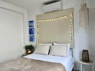 a bedroom with a bed with lights on it at STAY Blue House in Larnaka