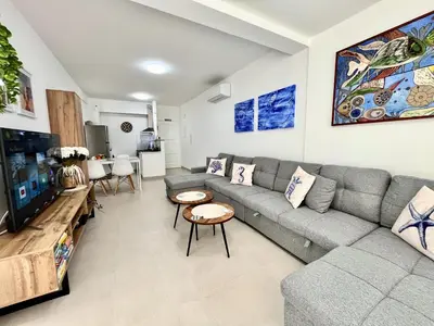 a living room with a couch and a tv at STAY Blue House in Larnaka