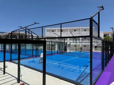a tennis court with two people on the court at Ocean Breeze 2BR House in Paralimni