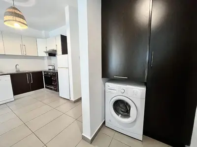 a kitchen with a washing machine in a room at STAY Tropical Apartment in Protaras