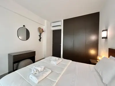 a bedroom with a white bed with towels on it at STAY Tropical Apartment in Protaras