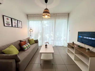 a living room with a couch and a tv at STAY Tropical Apartment in Protaras