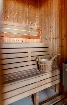 a wooden sauna with a bucket on the back of it at Epavli Papadopoulou - Luxury Villa - Pool & Garden in Kornos