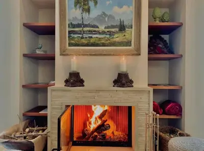 a fireplace in a living room with a fire in it at Epavli Papadopoulou - Luxury Villa - Pool & Garden in Kornos