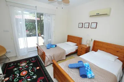a bedroom with two beds and a window at Villa Acanthus in Pissouri