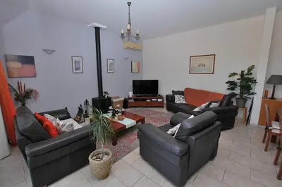 a living room with couches and a tv at Villa Acanthus in Pissouri