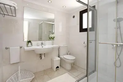 a bathroom with a sink and a toilet and a shower at Villa Greenery - Large Private Pool in Protaras