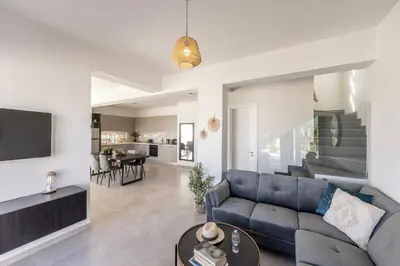 a living room with a blue couch and a table at Protaras Hestia Seaside Villa A6 in Protaras