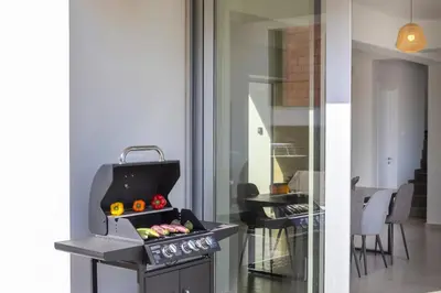 a kitchen with a grill with vegetables on it at Protaras Hestia Seaside Villa A6 in Protaras