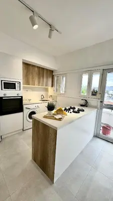 a kitchen with a stove top island in a room at The Perfect Lefkosa Stay - Zahra & Dereboyu & Ledra in Nicosia