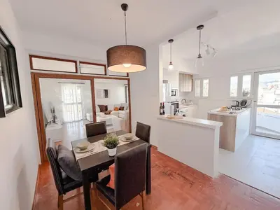 a dining room and kitchen with a table and chairs at The Perfect Lefkosa Stay - Zahra & Dereboyu & Ledra in Nicosia