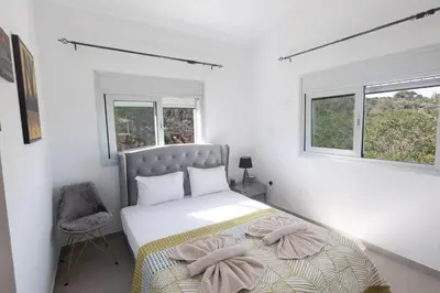 a bedroom with a bed with two pillows on it at Living the View in Protaras