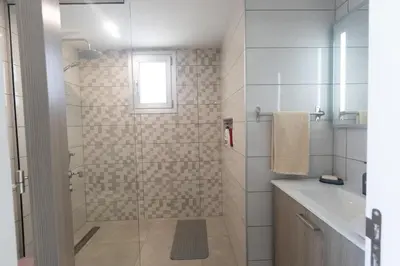 a bathroom with a shower with a glass door at Living the View in Protaras
