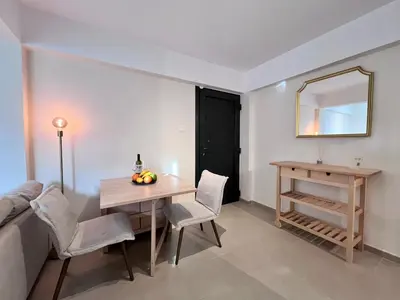 a dining room with a table and a mirror at Monte Napa Moments in Ayia Napa