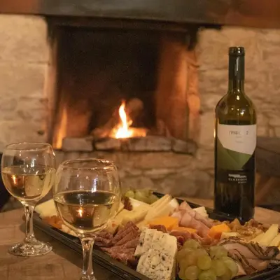 a plate of food and two glasses of wine at Stonehouse in Monagri
