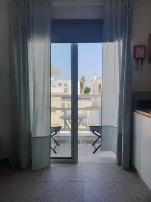 a sliding glass door with a view of a patio at Rainbow Apartments in Ayia Napa