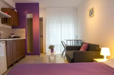 a living room with a couch and a kitchen at Rainbow Apartments in Ayia Napa
