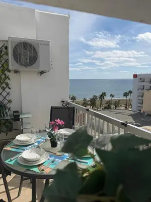 a table on a balcony with a view of the ocean at SeaScape Eight in Larnaka