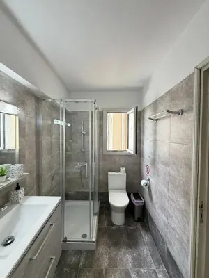 a bathroom with a shower and a toilet and a sink at SeaScape Eight in Larnaka