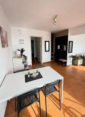 a living room with a white table and chairs at SeaScape Eight in Larnaka