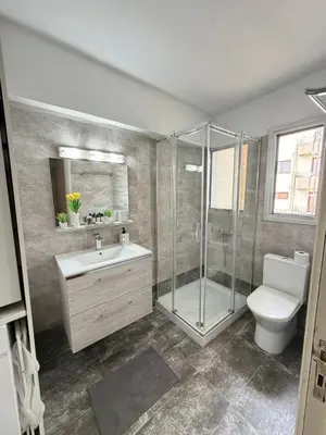 a bathroom with a shower and a sink and a toilet at SeaScape Eight in Larnaka