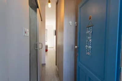 a hallway with a blue door and a hallway with a hallway at Studio in Limassol Coast in Limassol