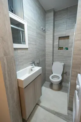 a bathroom with a white sink and a toilet at Studio in Limassol Coast in Limassol