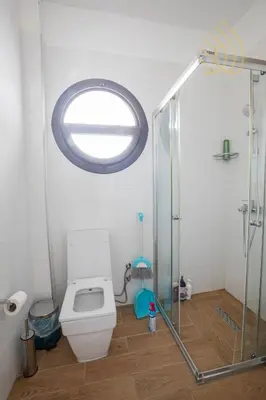 a bathroom with a toilet and a glass shower at Sea view Remus Family 2 bdr apartment in Nicosia