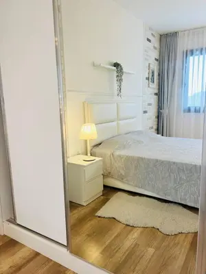 a bedroom with a bed and a large mirror at Sea view Remus Family 2 bdr apartment in Nicosia