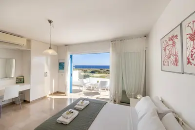 a bedroom with a bed and a view of the ocean at Protaras Seafront Villa Galene Del Mar in Protaras