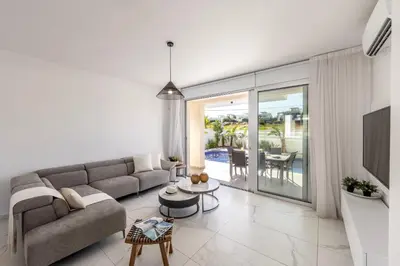 a living room with a couch and a table at Protaras Sol e Mar Villa 2 in Protaras