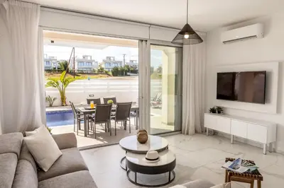 a living room with a couch and a table at Protaras Sol e Mar Villa 2 in Protaras